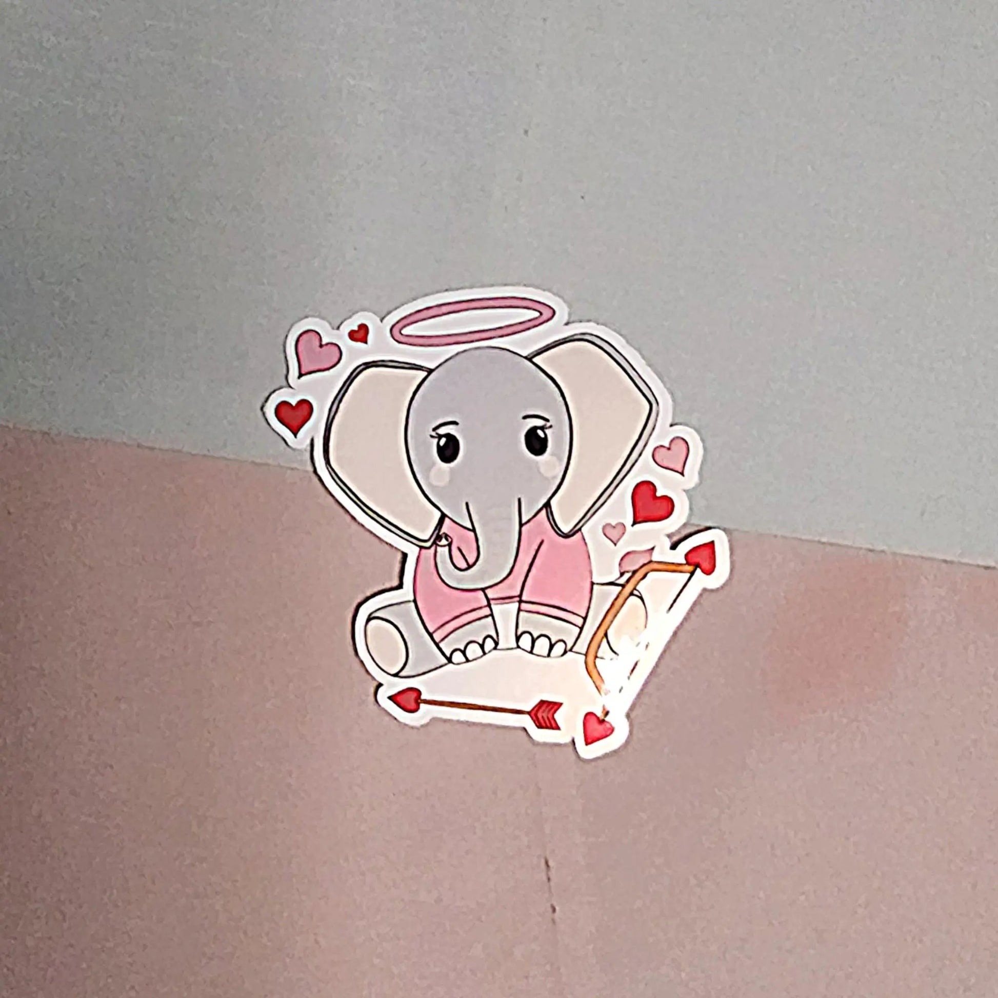 Cartoon elephant sticker with hearts and a halo