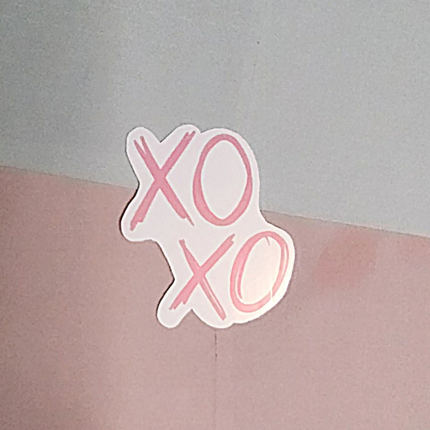 Sticker with "XO XO" in scribbled font in pink