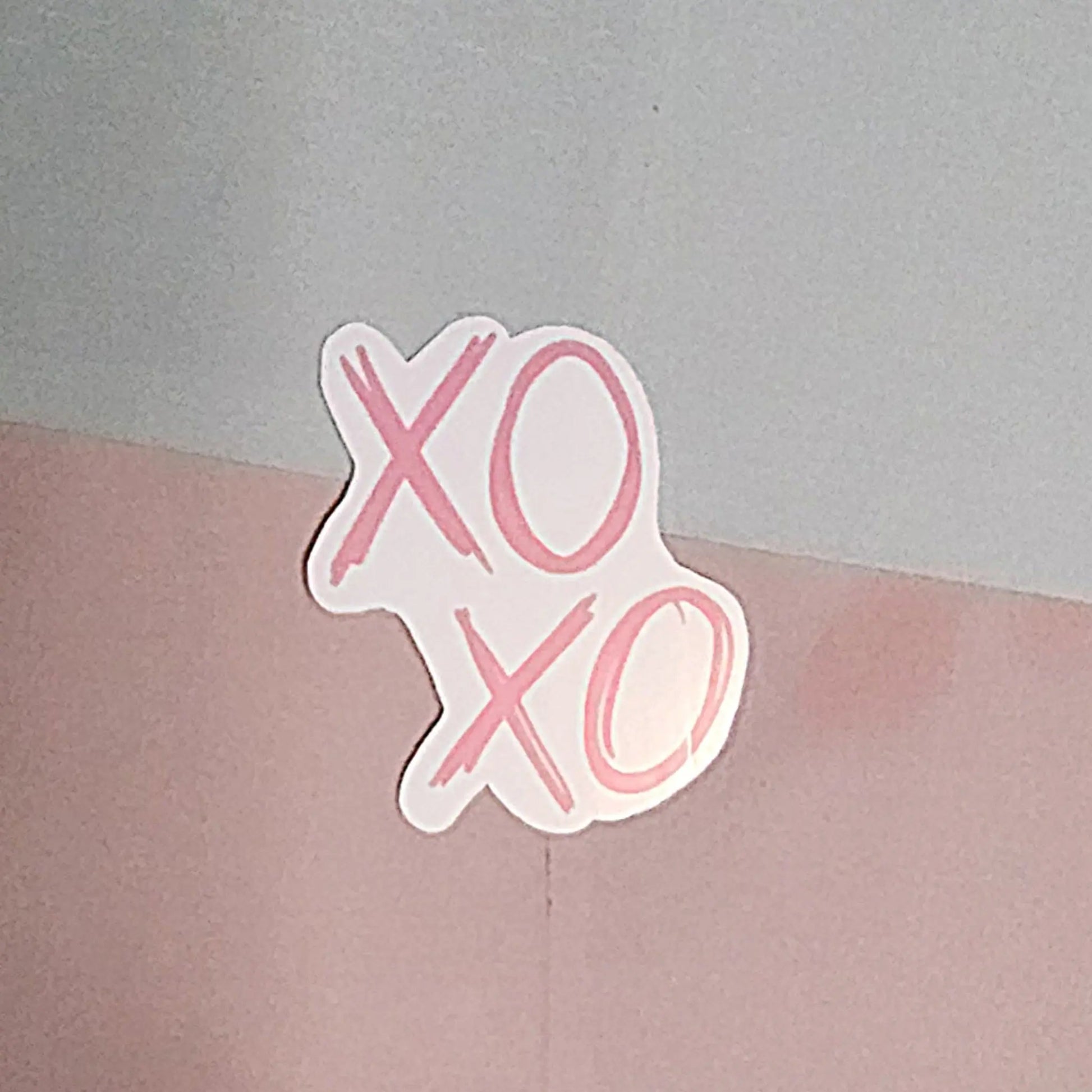 Sticker with "XO XO" in scribbled font in pink