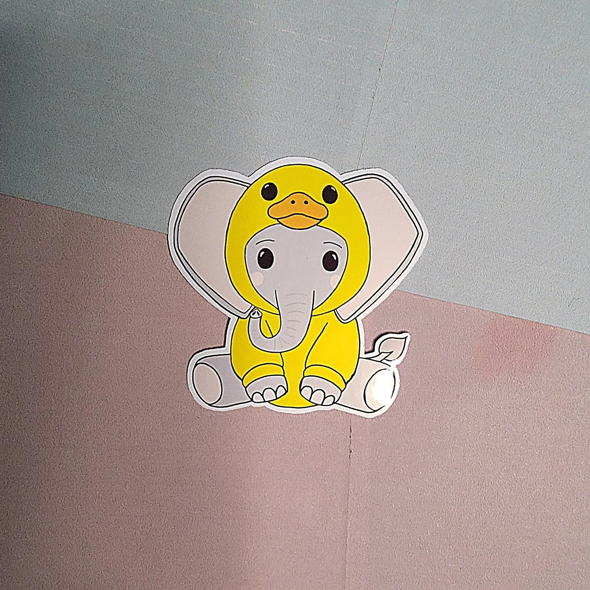Cartoon character of an elephant in a yellow duck costume