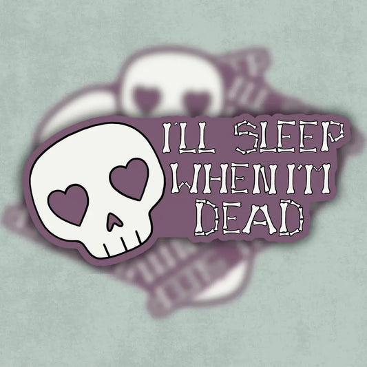 Vinyl skull sticker with heart eyes and 'I'll sleep when I'm dead' text on a mauve background